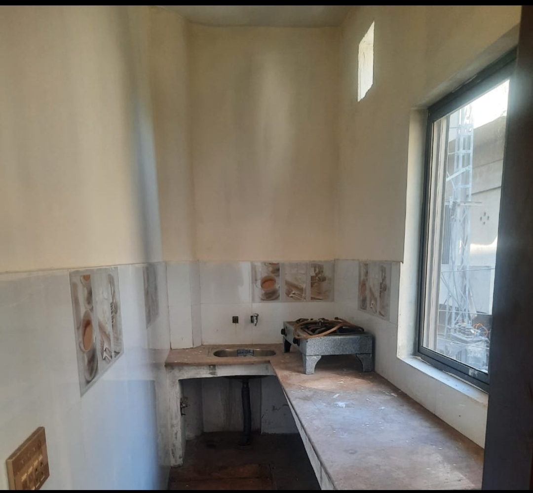 Resident Kitchen with Cooking Stove at The Second Home Boys Hostel Lahore
